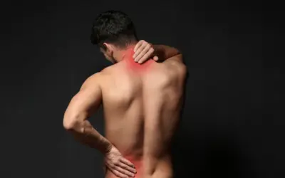 Man experiencing back and neck pain, illustrating common ailments related to aging and the importance of physical therapy.